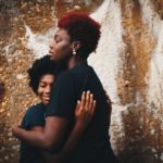 two black women embracing, diverse survivor communities