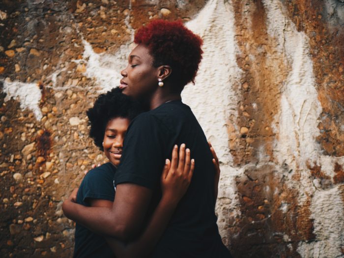 two black women embracing, diverse survivor communities