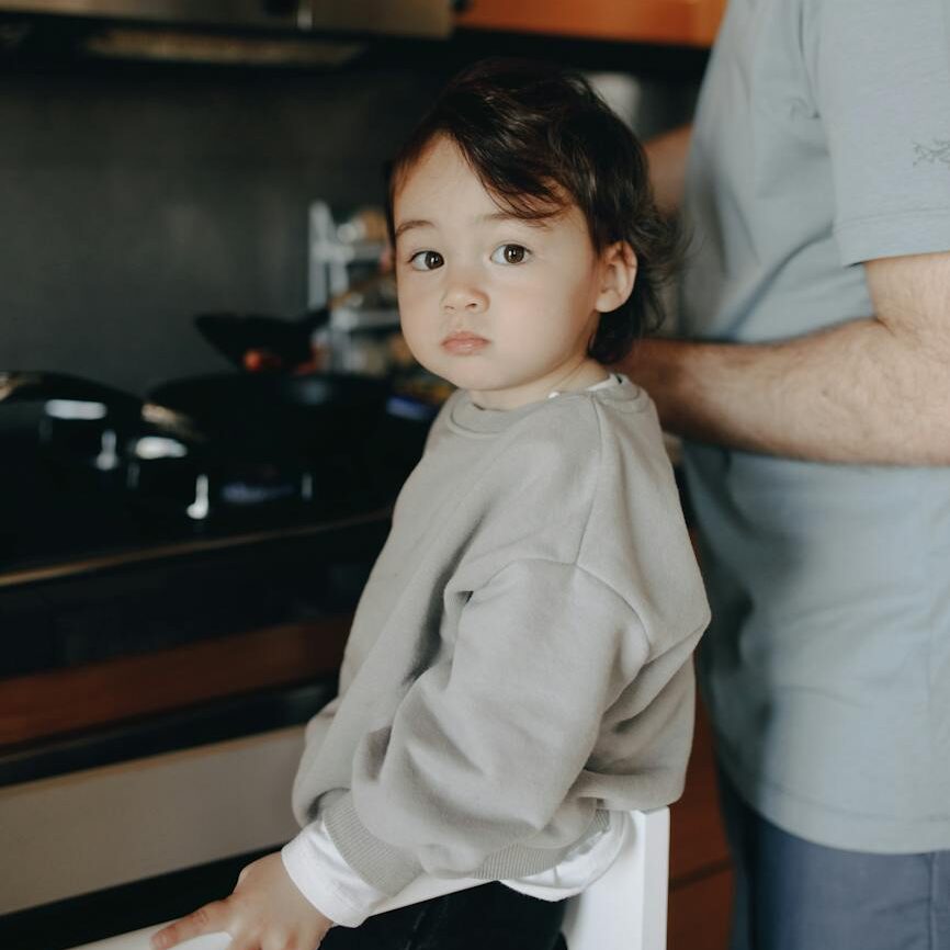 father cooking in the kitchen with her child
