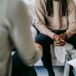 crop black man speaking with psychologist