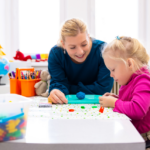 girl and mother playing w toys at a table