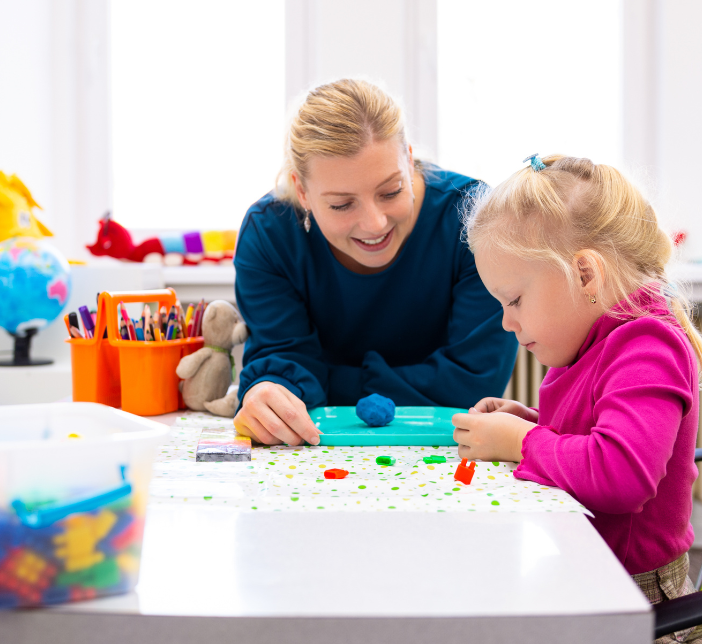 girl and mother playing w toys at a table